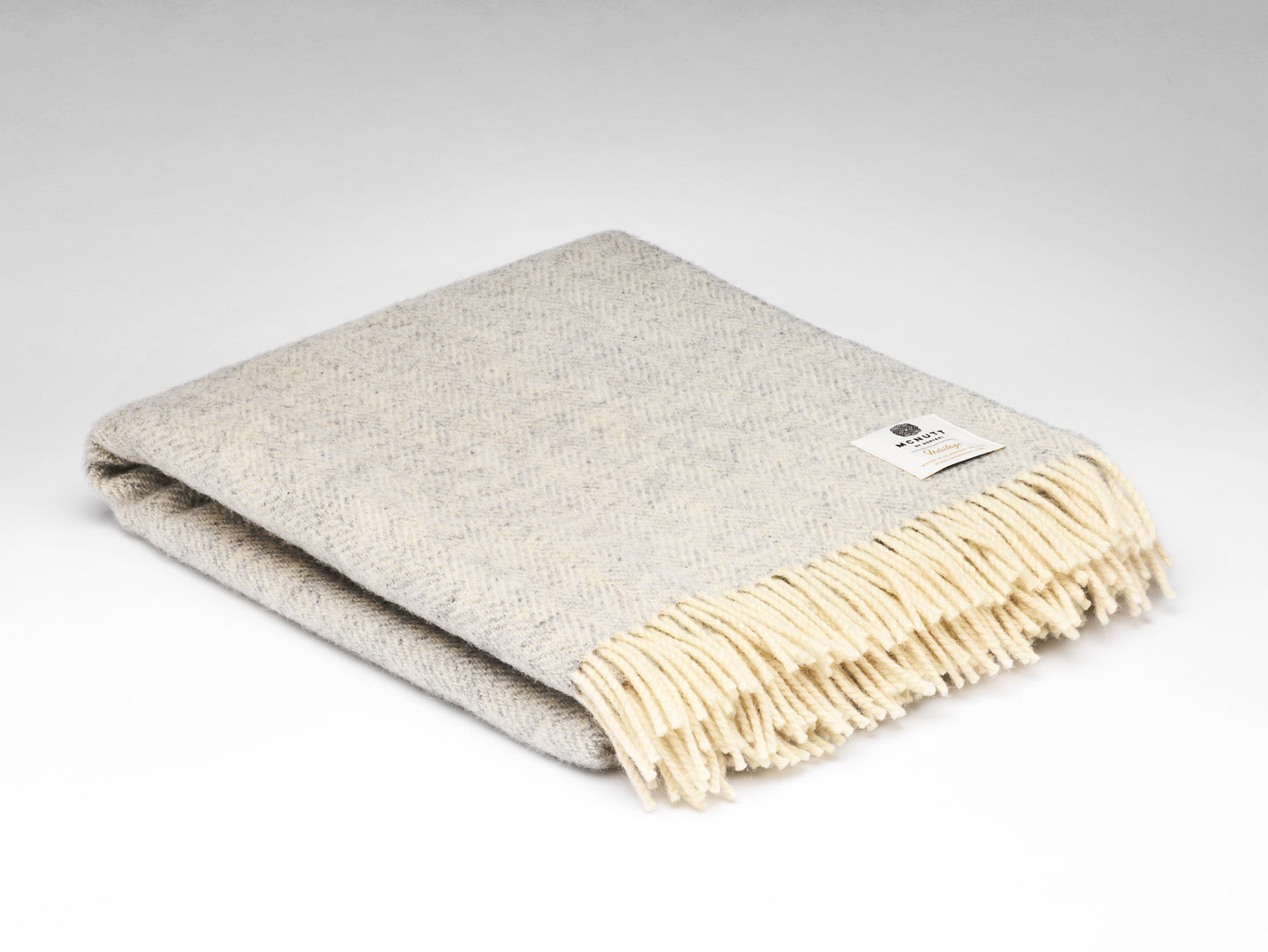 Beige blanket with frayed edge on a white background